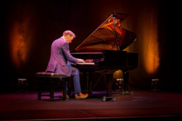 Alistair McGowan playing piano